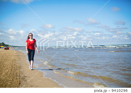 Girl walking near the sea in Jurmala, Latvia Girl walking near the sea in Jurmala, Latvia 9410296