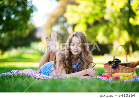 Beautiful girl on a picnic in park Beautiful girl on a picnic in park 9410364