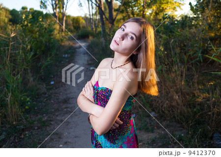 beautiful young woman with sensual look in the garden in summer 9412370
