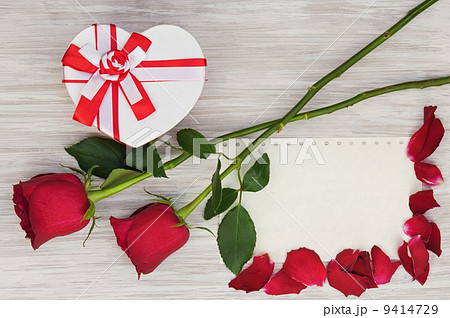 Valentine`s Day gift, roses and paper on wooden background. 9414729