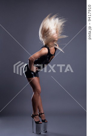 Slender blonde dancing in shoes with high heel 9417910