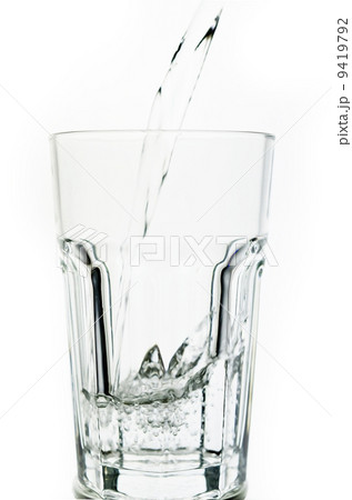 Filling a glass with water showing a drink concept 9419792