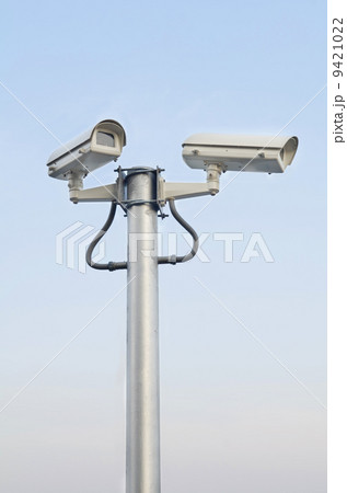 Security camera on blue sky background Security camera on blue sky background 9421022