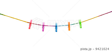 Clothespins on raimbow rope with modern wall background Clothespins on raimbow rope with modern wall background 9421024
