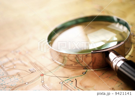 Magnifying glass lying on a map 9421141
