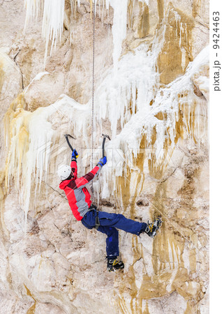 Young man climbing the ice 9424463