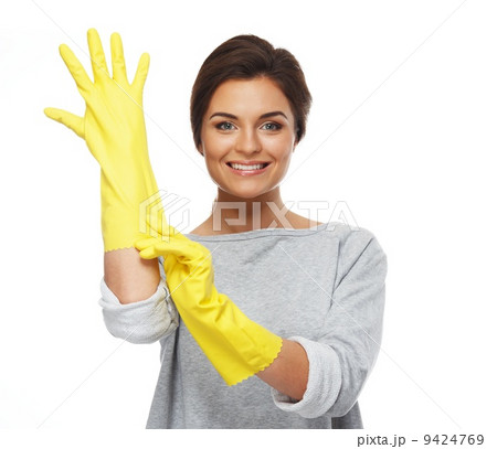 Beautiful cheerful brunette woman pulling on rubber gloves Beautiful cheerful brunette woman pulling on rubber gloves 9424769
