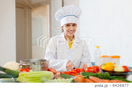cook works with vegetables at commercial kitchen cook works with vegetables at commercial kitchen 9426977
