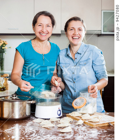 cooking mother with adult daughter cooking mother with adult daughter 9427080