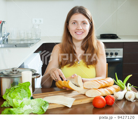 woman cooking sandwiches with baguette woman cooking sandwiches with baguette 9427120