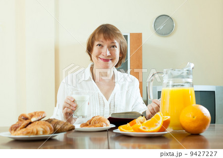 mature woman having breakfast mature woman having breakfast 9427227