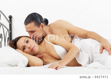 Middle-aged couple awaking in bed 9427471