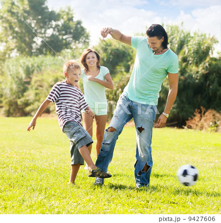 parents with child playing with soccer ball parents with child playing with soccer ball 9427606
