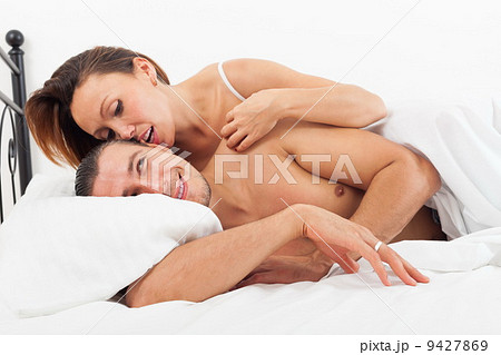 Middle-aged lovers kissing in bed Middle-aged lovers kissing in bed 9427869