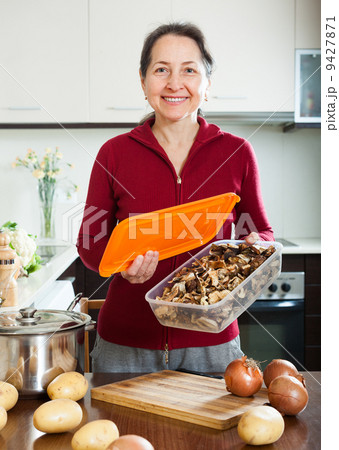mature housewife with dried mushrooms mature housewife with dried mushrooms 9427871