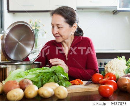 Mature woman in kitchen Mature woman in kitchen 9427873
