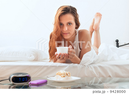 girl with mug of cafe in bed 9428000