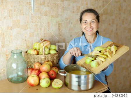 Woman cooks apple jam 9428042