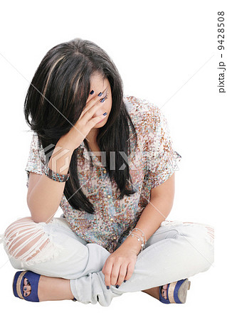 Dejected woman with hands on face sitting on floor Dejected woman with hands on face sitting on floor 9428508