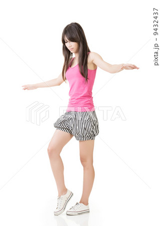 Young asian woman walking on imaginary rope Young asian woman walking on imaginary rope 9432437