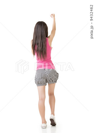 Young asian woman pulls an imaginary rope Young asian woman pulls an imaginary rope 9432462
