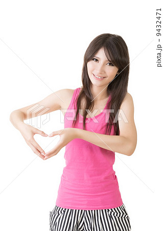 Smiling asian woman make heart shape with hands Smiling asian woman make heart shape with hands 9432471
