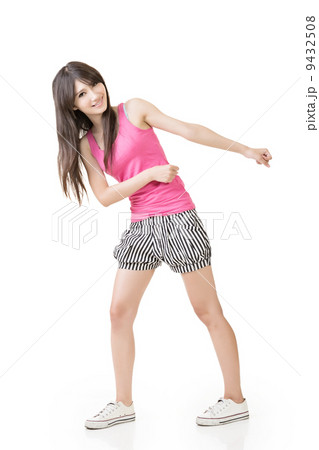Young asian woman pulls an imaginary rope Young asian woman pulls an imaginary rope 9432508
