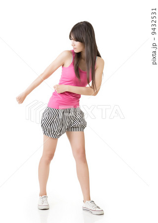 Young asian woman pulls an imaginary rope Young asian woman pulls an imaginary rope 9432531