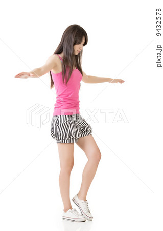 Young asian woman walking on imaginary rope Young asian woman walking on imaginary rope 9432573