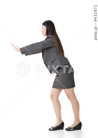 Asian business woman pushing Asian business woman pushing 9432971