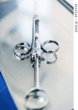 Empty dental syringe on steel surface 9434448