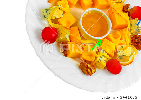 Different types cheese appetizer with honey, nuts and grapes on 9441039