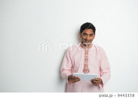 traditional indian male with tablet and plenty of copyspace traditional indian male with tablet and plenty of copyspace 9443358