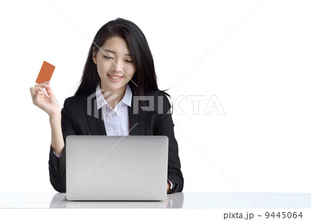 Business woman online shopping browsing laptop holding credit card studio white background 9445064