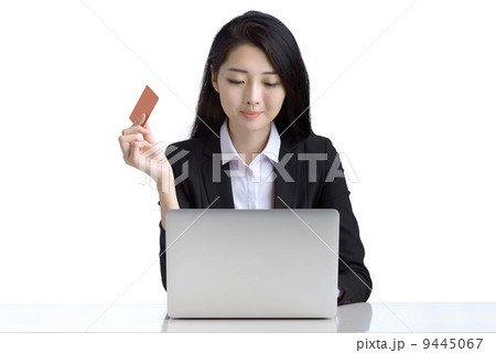 Business woman online shopping browsing laptop holding credit card studio white background Business woman online shopping browsing laptop holding credit card studio white background 9445067
