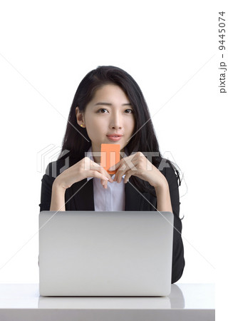 Business woman online shopping browsing laptop holding credit card studio white background 9445074