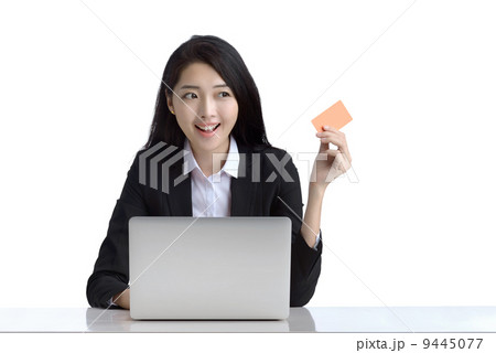 Business woman online shopping browsing laptop holding credit card studio white background 9445077