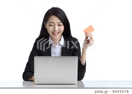 Business woman online shopping browsing laptop holding credit card studio white background Business woman online shopping browsing laptop holding credit card studio white background 9445078