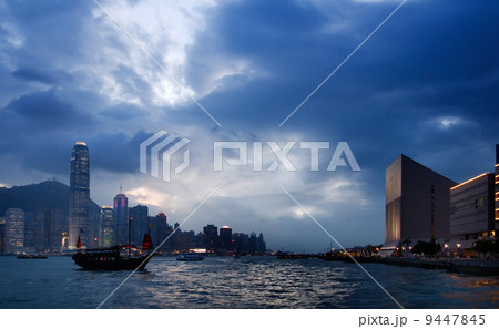 sunset cityscape of Victoria harbor with old Chinese style boat in Hong Kong 9447845