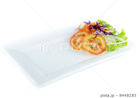 Plate and salad on top plate on white background 9448285