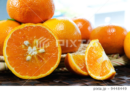 tangerines with leaves in a beautiful basket, on wickerwork tabl tangerines with leaves in a beautiful basket, on wickerwork tabl 9448449