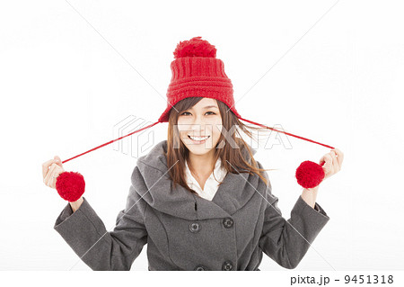 happy young woman wearing winter coat and cap 9451318