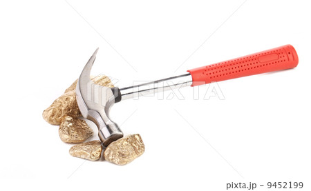 Closeup of metal hammer with gold nuggets. Closeup of metal hammer with gold nuggets. 9452199