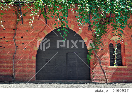 Red brick house with wooden door in Italy. 9460937