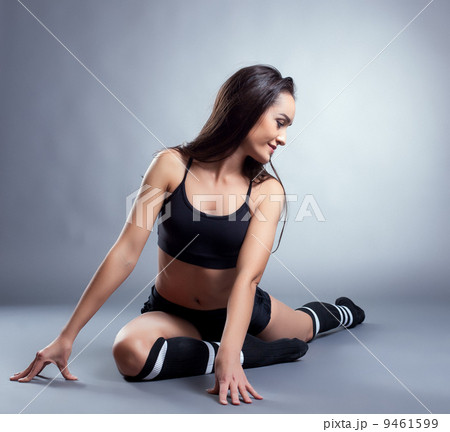 Image of pretty slim brunette doing stretching 9461599