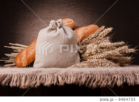 Bread, flour sack and ears bunch still life 9464735