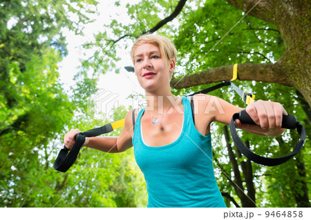 woman doing suspension sling trainer sport 9464858