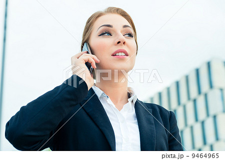 Confident businesswoman talking on business phone 9464965