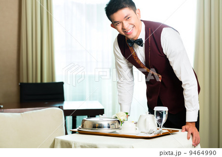 Asian Chinese room service waiter serving food in hotel Asian Chinese room service waiter serving food in hotel 9464990