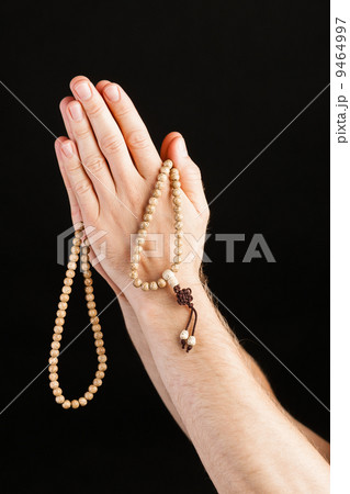 Hand praying with chain 9464997